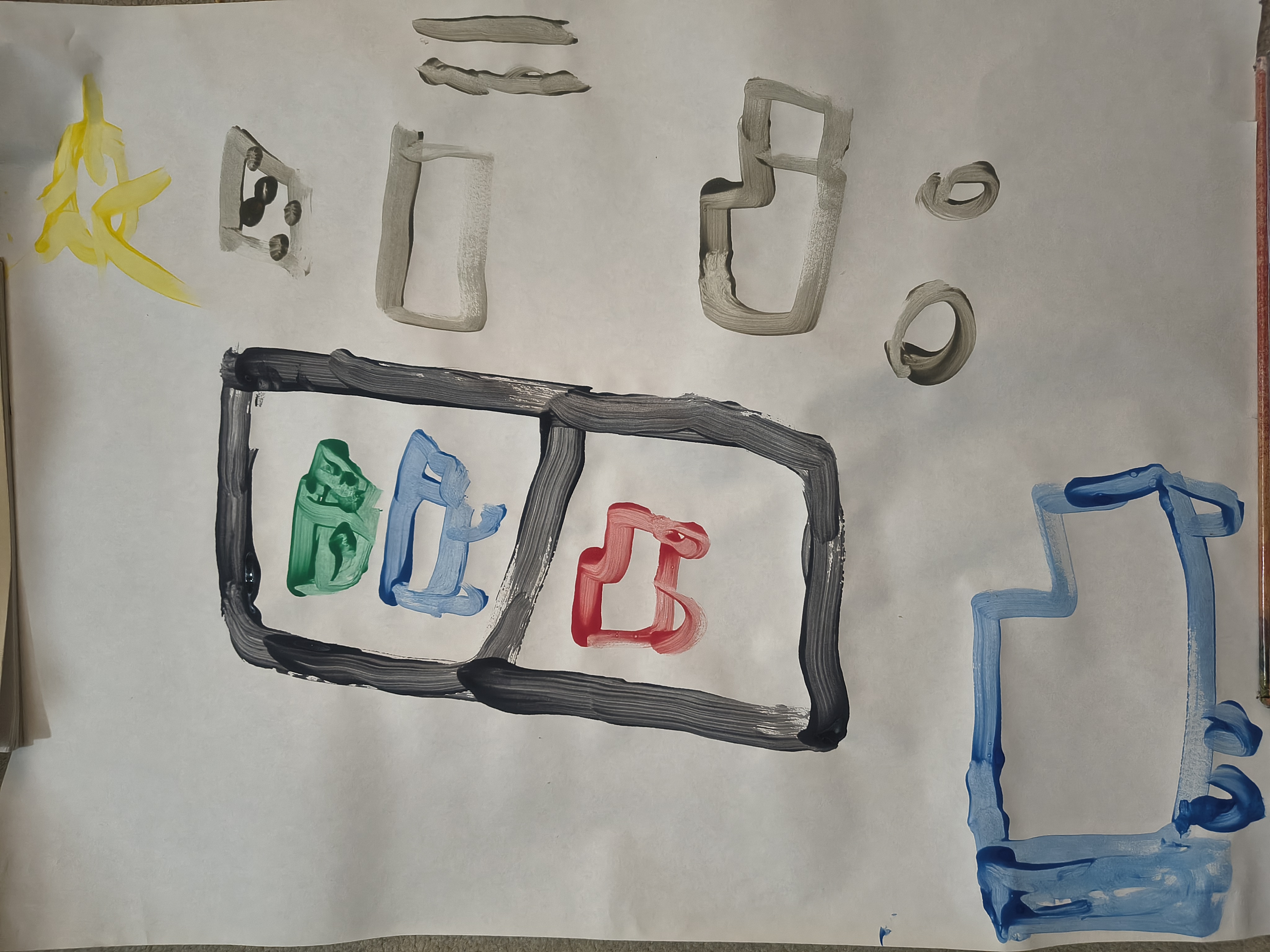 A child's painting on white paper depicting several cars and trucks. In the center is a large car carrier, outlined in black, holding a green, a blue, and a red car. To the right and bottom are several other cars and trucks painted in grey and blue. At the top right, there's a bright yellow sun.